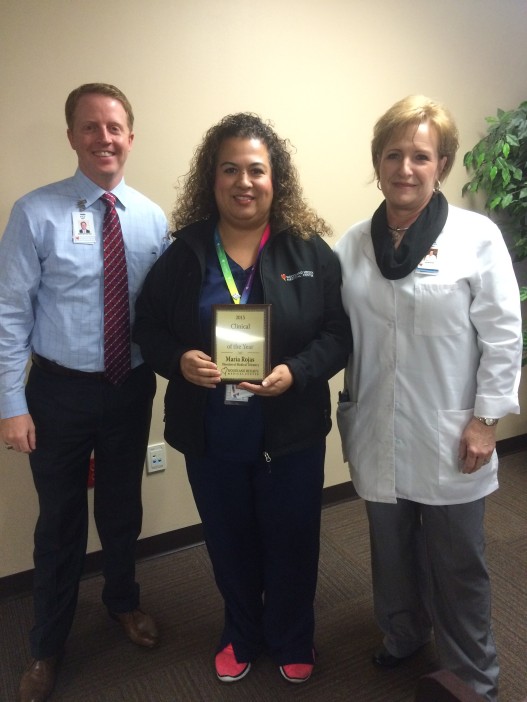 Kyle Swift, CEO of Woodland Heights (left) and Cathy Busbee, CNO of Woodland Heights (right) award Maria Rojas, Director of Medical/Telemetry Unit, the Clinical Director of the Year Award for 2015. (Photo: Woodland Heights Medical Center)
