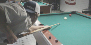 (Photo by: Bethany Baldwin) Cohle Felder goes for a right corner pocket shot during a match at Grant Street private pool hall.