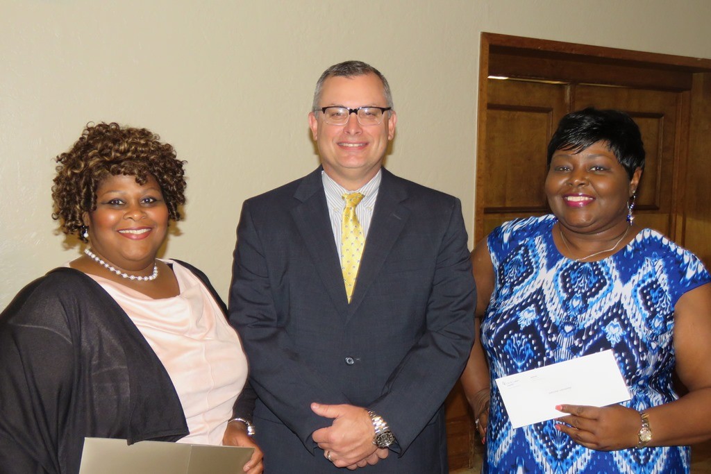 Eddie Mae Simmons and Denise Menefee received 25 year service awards from Shawn Barnett, CHI St. Luke’s Health Memorial Market President. (Not pictured: Patricia Isbell and Cynthia Kendrick)