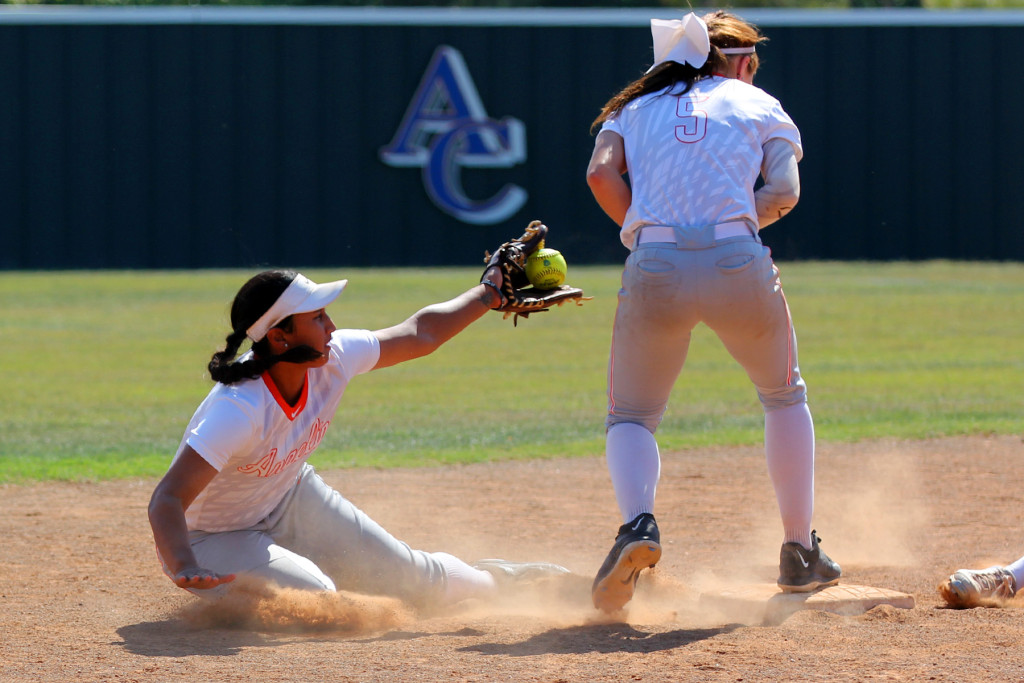 Angelina College second baseman Shay Vegas tries to scoop the ball to shortstop Bryli Lee during Monday’s doubleheader against Trinity Valley College. The No. 15 Lady Roadrunners won the nightcap 4-2 after dropping the opener 1-0 at Roadrunner Complex. (Photo by AC News Service)