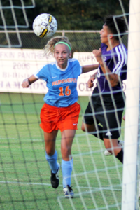 Angelina College’s Carley Elkins (16) heads a ball past a Ranger defender during Tuesday’s match in Lufkin. Elkins missed this attempt, but would net another one later as the Lady Roadrunners notched the program’s first-ever victory, a 2-0 win over the Lady Rangers. (AC Press photo/Gary Stallard)