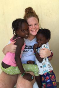 Missionary Kassidy Eberlan, center, takes a photo with Haitians Annanee, left, and Dashca.
