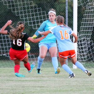 Angelina College keeper Kelly Copeland and teammate Carley Elkins (16) team up to save a shot attempt from Navarro’s Karina Trejo during Saturday’s match. The Lady Bulldogs scored late to take a 1-0 win over the Lady Roadrunners, leaving AC as the No. 4 seed heading into Wednesday’s conference tournament. (AC Press photo/Gary Stallard)