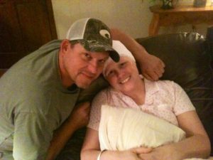 Jessica Knight, left, and her husband, Bobby, pose for a picture together during the time she was battling breast cancer.