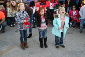 Three young girl cheering to wake up Santa Claus.