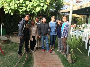 A photo of Chris Rudd, center, and his wife Miranda, right of him, and their host family in Bolivia.