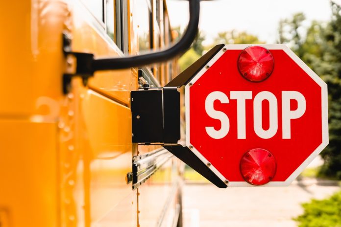 editclose-up-yellow-school-bus-stop-sign-be-careful-2021-10-21-02-46-08-utc