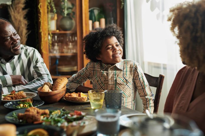 little-boy-having-dinner-with-family-2022-04-20-15-13-38-utc-min