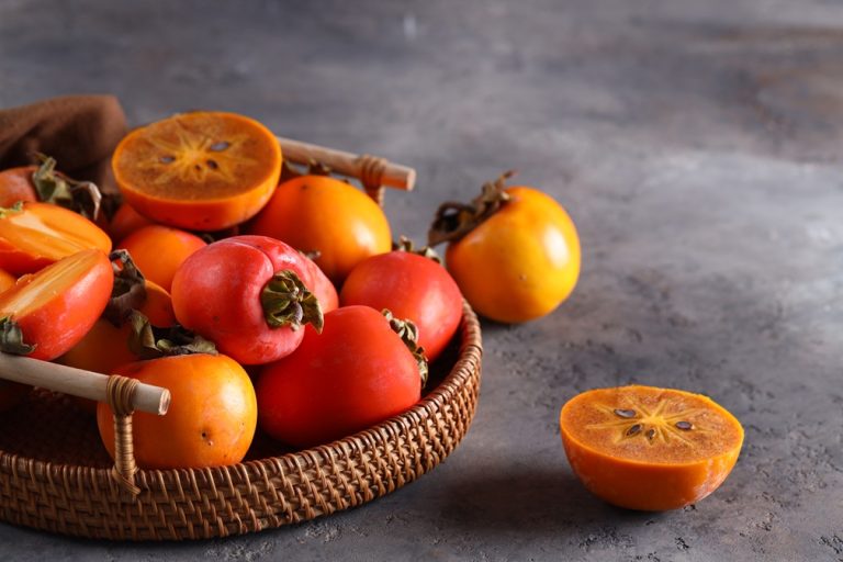 ripe persimmon orange fruit in a basket
